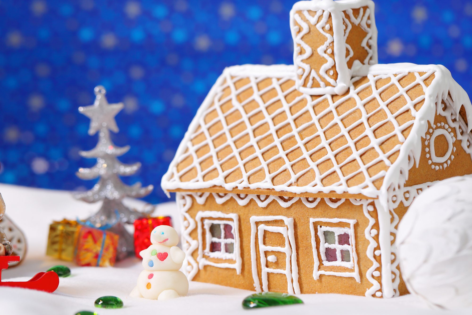 Christmas card with gingerbread house and tree with decorations